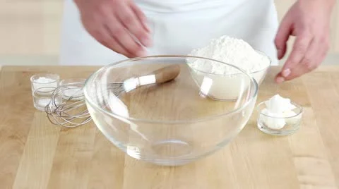 Vegetable fat being added to a flour and baking powder mixture Stock Footage 24672996