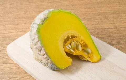 Vegetable, Fresh Raw and Slice Pumpkin on A Wooden Cutting Board. Stock Photos