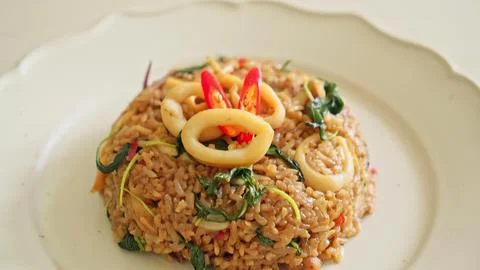 Vegetable fried rice dish on white plate with colorful toppings Stock Photos