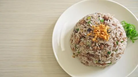 Vegetable fried rice on white plate with green garnish Stock Photos
