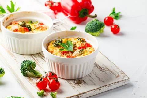 Vegetable frittata with broccoli, red bell pepper and red onion in cast iron  Stock Photos
