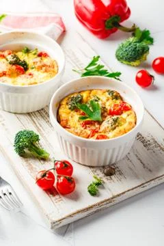 Vegetable frittata with broccoli, red bell pepper and red onion in cast iron  Stock Photos