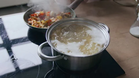 Vegetable Frying and Spaghetti Boiling Process in Kitchen Stock Footage 302419061