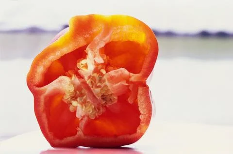Vegetable, half cut red capsicum and seeds on white background Stock-Fotos