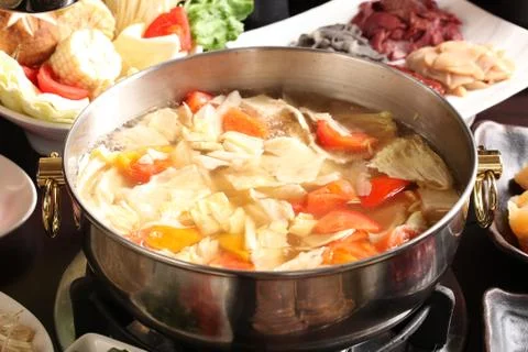 Vegetable hot pot with corn, cabbage, tomato, beef and pork in chinese stew Stock Photos