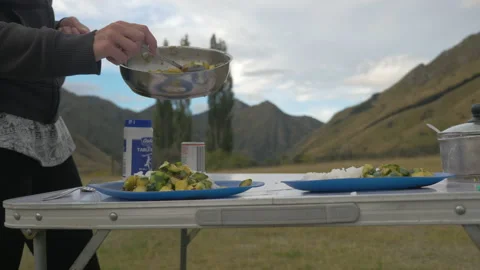 Vegetable meal on a picnic table during a roadtrip, in New Zealand Stock Footage 219890973