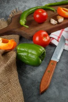 Vegetable mix and a knife on a rustic background. Stock Photos