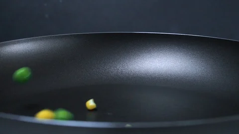 The vegetable mix is poured into the pan. Broccoli, peas, carrots, asparagus Vídeo Stock 89841925