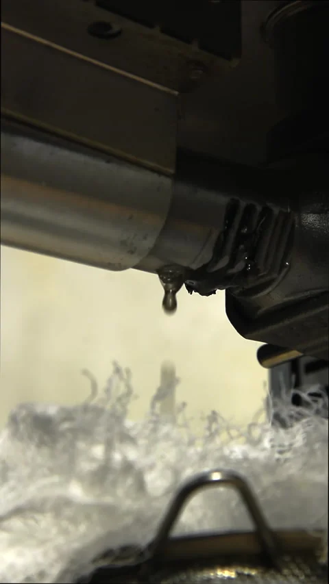 Vegetable oil drips into the filter on the container from the electric oil press Stock Footage 168889977