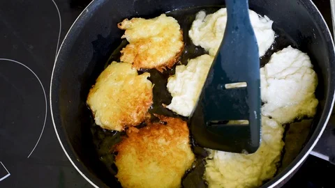 Vegetable pancakes are cooked in vegetable oil in a frying pan Stock Footage 94014731