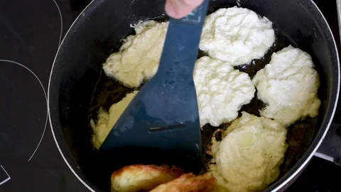 Vegetable pancakes are cooked in vegetable oil in a frying pan Stock Footage 94014780