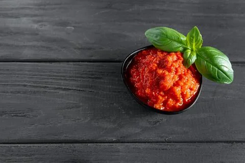 Vegetable paste, on a dark wooden backdrop in a black basil leaf pie Stock Photos