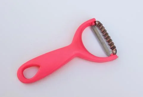 Vegetable peeler on white background Stock Photos