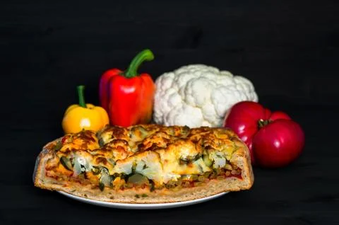 Vegetable pie in a section with a set of vegetables for making the filling. T Stock Photos