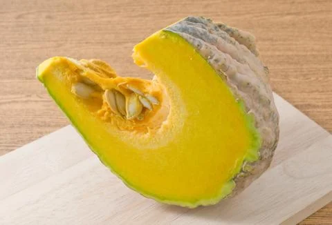 Vegetable, Raw and Slice Pumpkin on A Wooden Cutting Board. Stock Photos