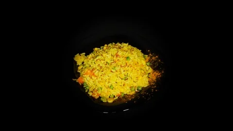 Vegetable risotto in the spinning table isolated on black background in black 스톡 동영상 104722786