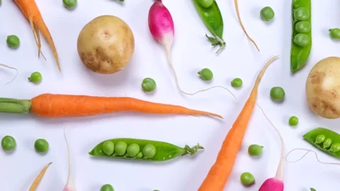 Vegetable rotating background of potatoes, peas, carrots and radishes Stock Footage 198638397