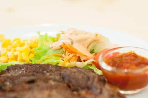 Vegetable salad and Sliced medium rare grilled Beef steak Ribeye with tomato Stock Photos