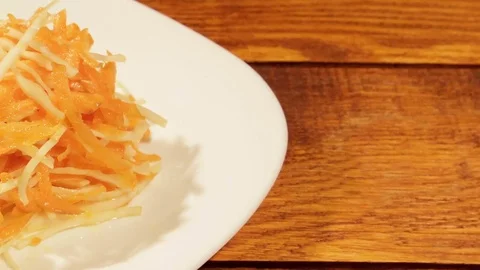 Vegetable salad of carrot and cabbage on wooden background close up. Stock Footage 74508146
