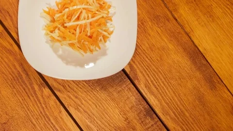 Vegetable salad of carrot and cabbage on wooden background close up. Stock Footage 74508155