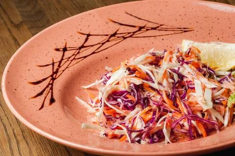 Vegetable salad of chopped cabbage of various types and with carrots Stock Photos