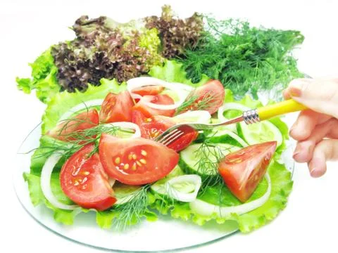 Vegetable salad with fork in hand Stock Photos