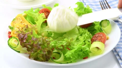Vegetable salad with poached egg. A boiled egg is laid out on a plate with fresh Stock Footage 146155035