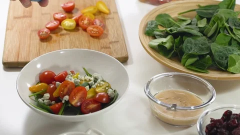 Vegetable salad preparation process. Baby spinach salad with some ingredients Video stock 125968847