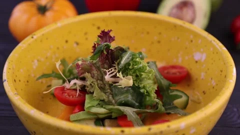 Vegetable salad in a yellow plate. The camera rotates around the plate Stock Footage 155455756