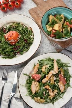 Vegetable salads on light gray background top view menu Stock Photos