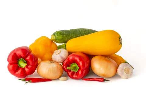 Vegetable set of bright ripe appetizing fruit peppers onion zucchini and garl Stock Photos