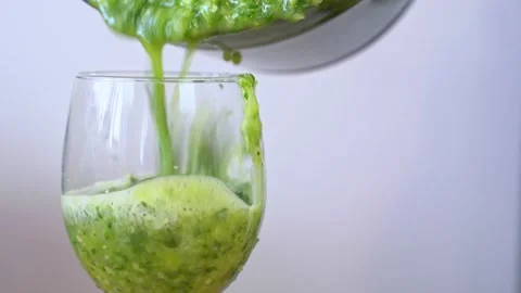 Vegetable smoothie, freshly squeezed celery juice poured from blender into glass Stock Footage 271435345