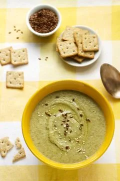 Vegetable soup with broccoli, served with crackers, linseed oil and seeds. Stock Photos