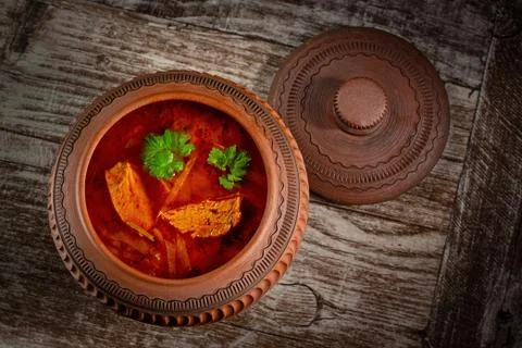 Vegetable soup in ceramic pot on rustic wooden background Stock Photos