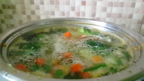 Vegetable soup cooked in a pan slow motion Stock Footage 114870365