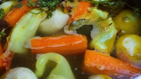 Vegetable soup is cooked slowly Stock Footage 241938377