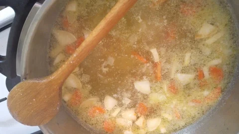 Vegetable soup cooks in a pan. Stock Footage 122210807