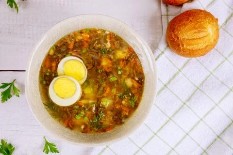 Vegetable soup with egg and crusty rolls. Stock Photos
