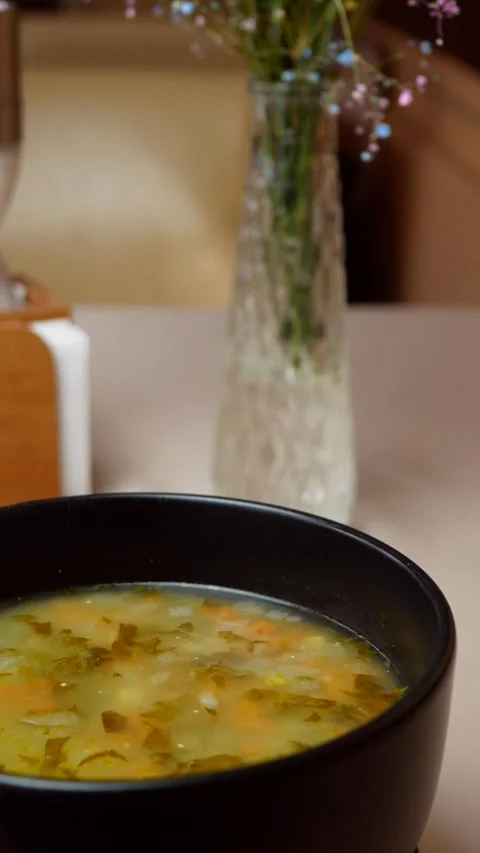 Vegetable soup in a rotating plate, close-up Stock Footage 309016937