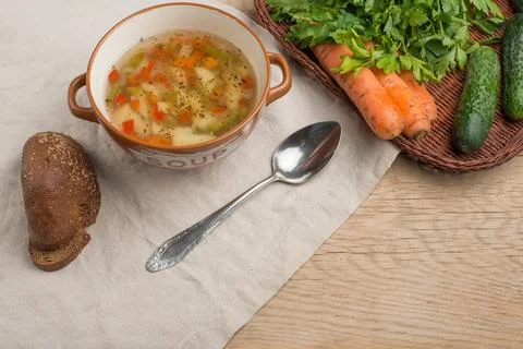 Vegetable soup, surrounded by fresh vegetables. With empty space for writing Stock Photos