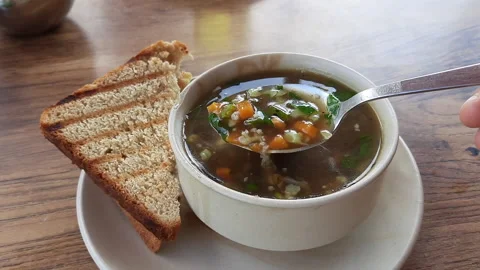 Vegetable soup with toasted bread and spoon. Meal for dinner or lunch. Stock Footage 218234153