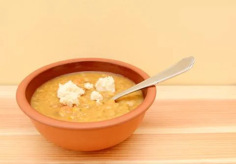 Vegetable soup with torn bread pieces on top Stock Photos
