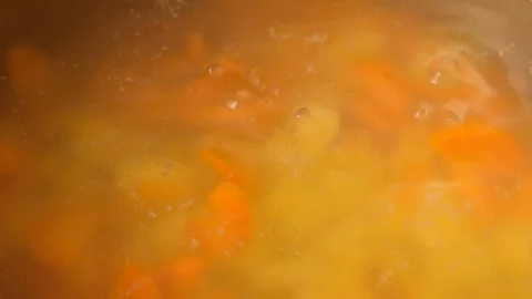 Vegetable soup. Vegetables in boiling water. Potatoes, carrots, onions, peas Stock Footage 121853701