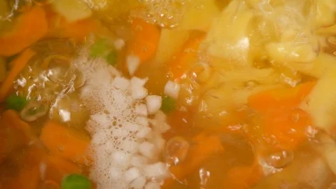 Vegetable soup. Vegetables in boiling water. Potatoes, carrots, onions, peas Stock Footage 121853927