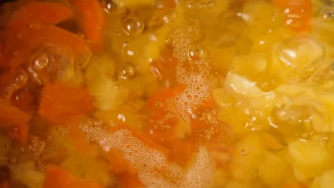 Vegetable soup. Vegetables in boiling water. Potatoes, carrots, onions, peas Stock Footage 121854564