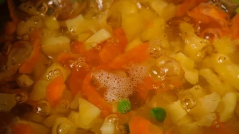 Vegetable soup. Vegetables in boiling water. Potatoes, carrots, onions, peas Stock Footage 121854599