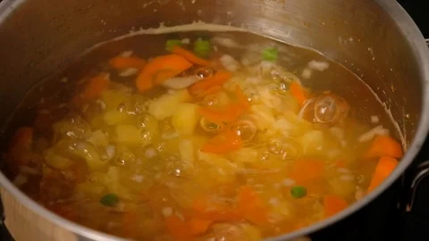 Vegetable soup. Vegetables in boiling water. Potatoes, carrots, onions, peas Stock Footage 121854635