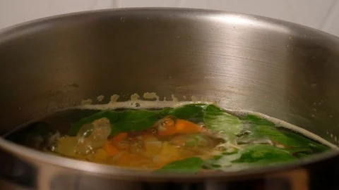Vegetable soup. Vegetables in boiling water. Potatoes, carrots, onions, peas Stock Footage 121854688