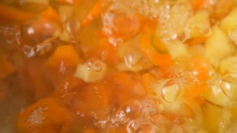 Vegetable soup. Vegetables in boiling water. Potatoes, carrots, onions, peas Stock Footage 129694603