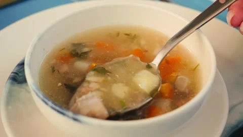 Vegetable soup with white fish and seafood seasoned with herbs, greens and Stock Footage 319005508
